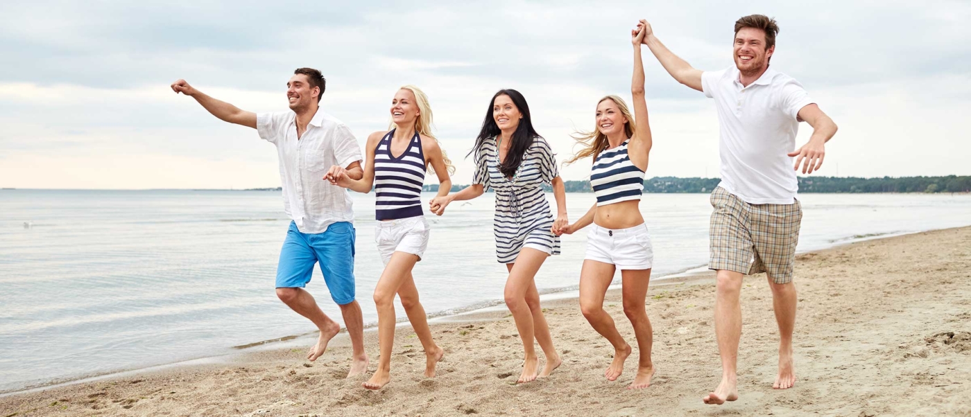 Picture of five people holding hands on the beach